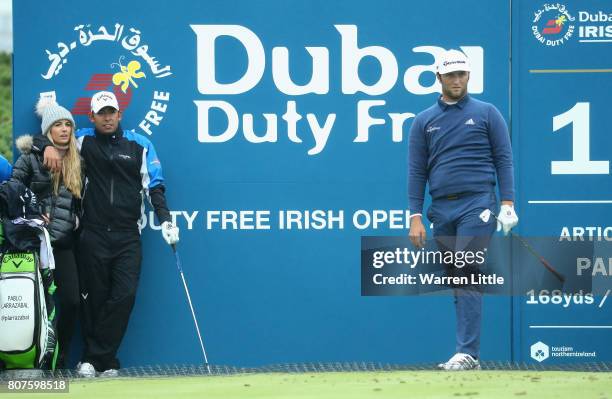 Pablo Larrazabal and his wife Gala Alten watch Jon Rahm of Spain during previews ahead of the Dubai Duty Free Irish Open at Portstewart Golf Club on...