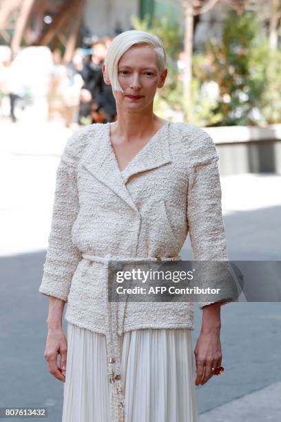 British actress Tilda Swinton poses during the photocall before Chanel 2017-2018 fall/winter Haute Couture collection show in Paris on July 4, 2017....