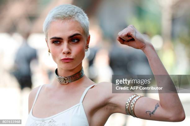 British model and actress Cara Delevingne poses during the photocall before Chanel 2017-2018 fall/winter Haute Couture collection show in Paris on...