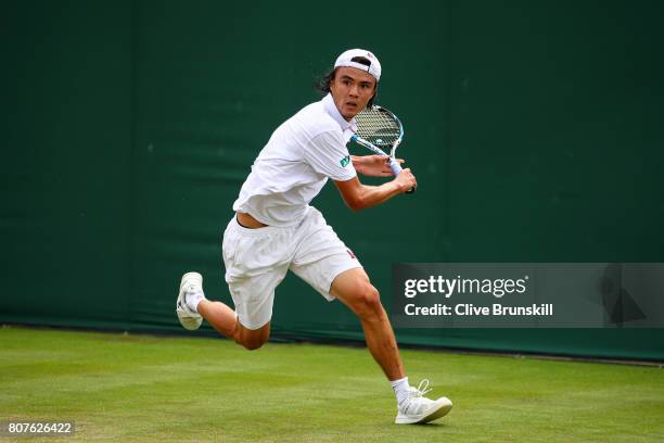 Taro Daniel of Japan plays a backhand shot during the Gentlemen's Singles first round match against Mikhail Kukushkin of Kazakhstan on day two of the...