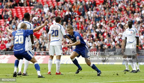 Millwall's Paul Robinson celebrates scoring his sides first goal of the game with teammate Steve Morison as Swindon Town players stand dejected