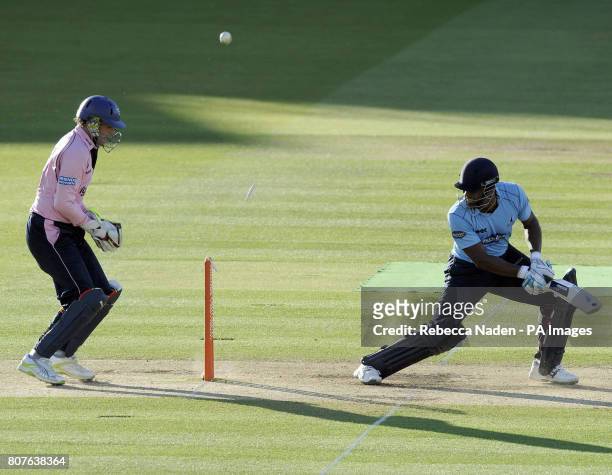 Middlesex Panthers wicketkeeper Adam Gilchrist watches Sussex Sharks Michael Yardy being bowled for 49 runs during the Friends Provident T20 match at...