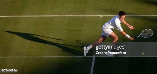 Tim Henman of Great Britain plays a backhand during the Men's Singles first round match against Carlos Moya of Spain on day one of the Wimbledon Lawn...