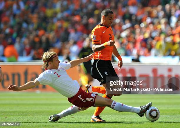 Denmark's Christian Poulsen and Netherlands' Gregory Van Der Wiel battle for the ball