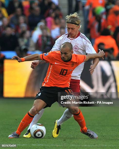 Netherlands' Wesley Sneijder holds off Denmark's Simon Kjaer