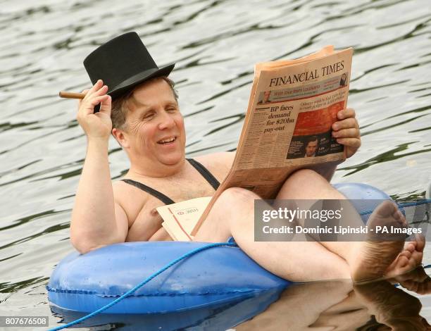 Businessman dressed in a mankini floats on a rubber ring on the Serpentine in Hyde Park, central London, during a photocall for new 'community led'...