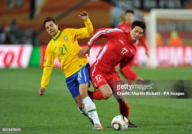 Brazil's Honorato da Silva Nilmar and Korea DPR's Yong-Hak Ahn battle for the ball