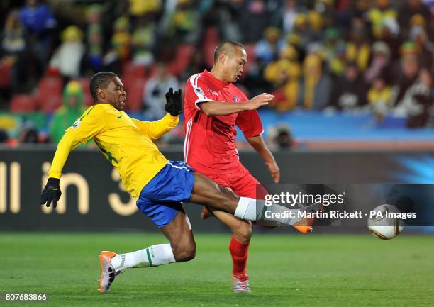 Korea DPR's Tae-Se Jong and Brazil's Silveira Juan battle for the ball