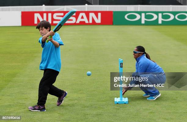 Anisa Mohammed of The West Indies takes works with local school children during an ICC Cricket for Good clinic at The County Ground on July 4, 2017...