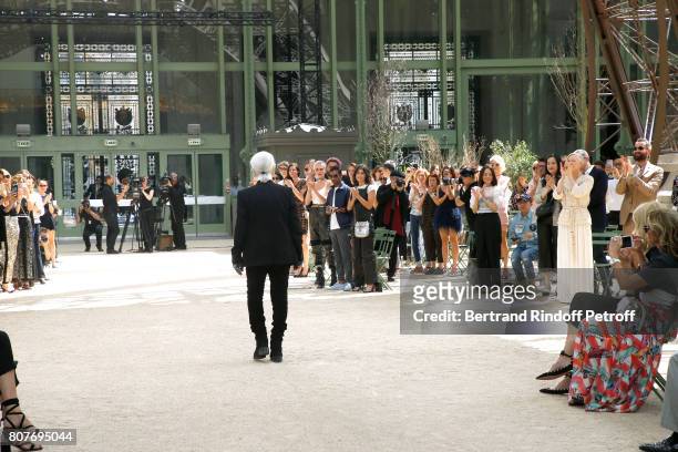 Stylist Karl Lagerfeld acknowledges the applause of Cara Delevingne, Aziz Ansari, Alessandra Mastronardi, Tilda Swinton, her husband Sandro Kopp and...