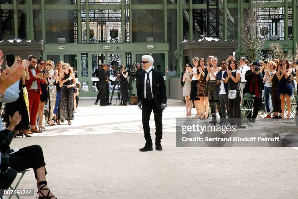 Stylist Karl Lagerfeld acknowledges the applause of Cara Delevingne, Aziz Ansari, Alessandra Mastronardi and all the audience at the end of the...