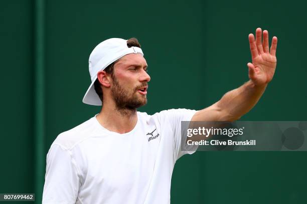 Daniel Brands of Germany gestures during the Gentlemen's Singles first round match against Gael Monfils of France on day two of the Wimbledon Lawn...