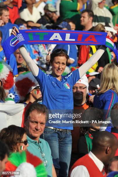 An Italy fan shows her support in the stands