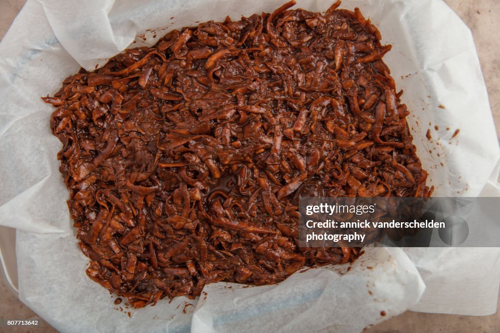 Oven dish with baking paper and brownie of sweet potato batter.