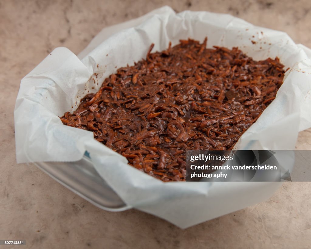 Oven dish with baking paper and brownie of sweet potato batter.