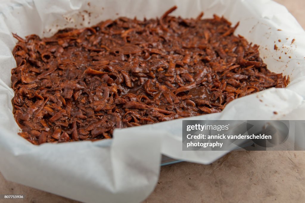 Oven dish with baking paper and brownie of sweet potato batter.