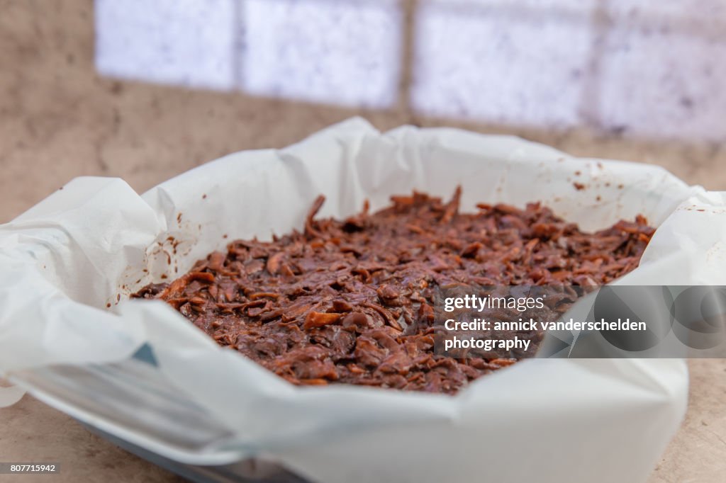 Oven dish with baking paper and brownie of sweet potato batter.