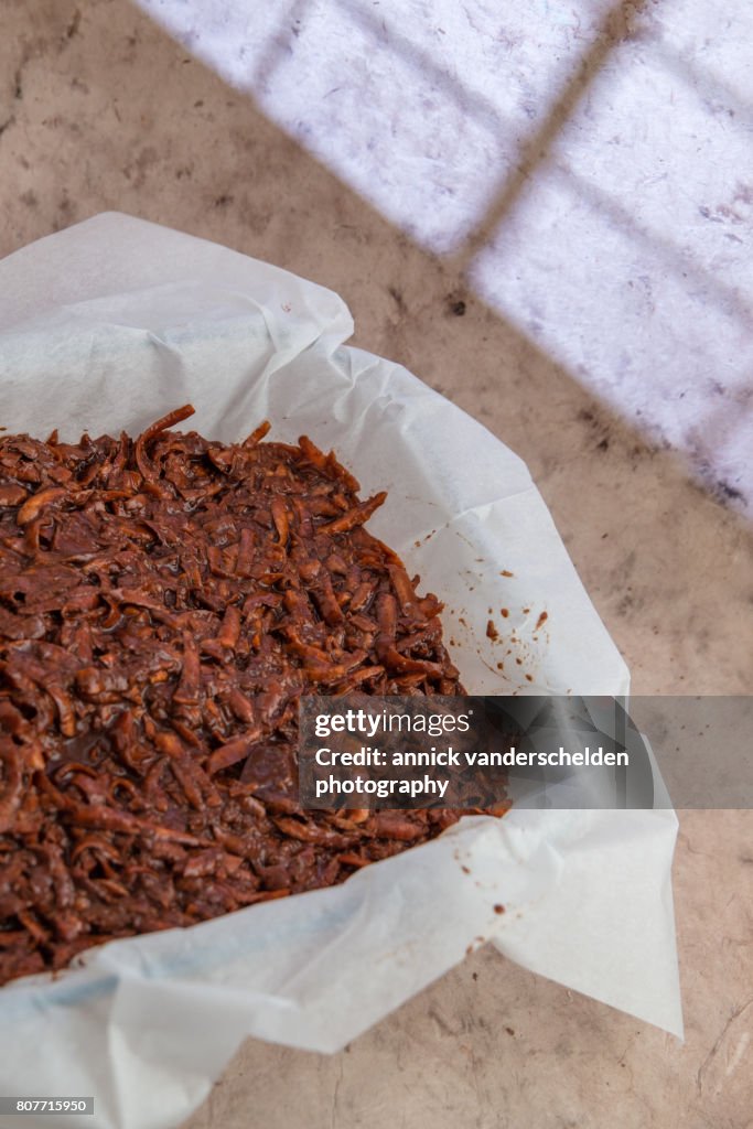 Oven dish with baking paper and brownie of sweet potato batter.