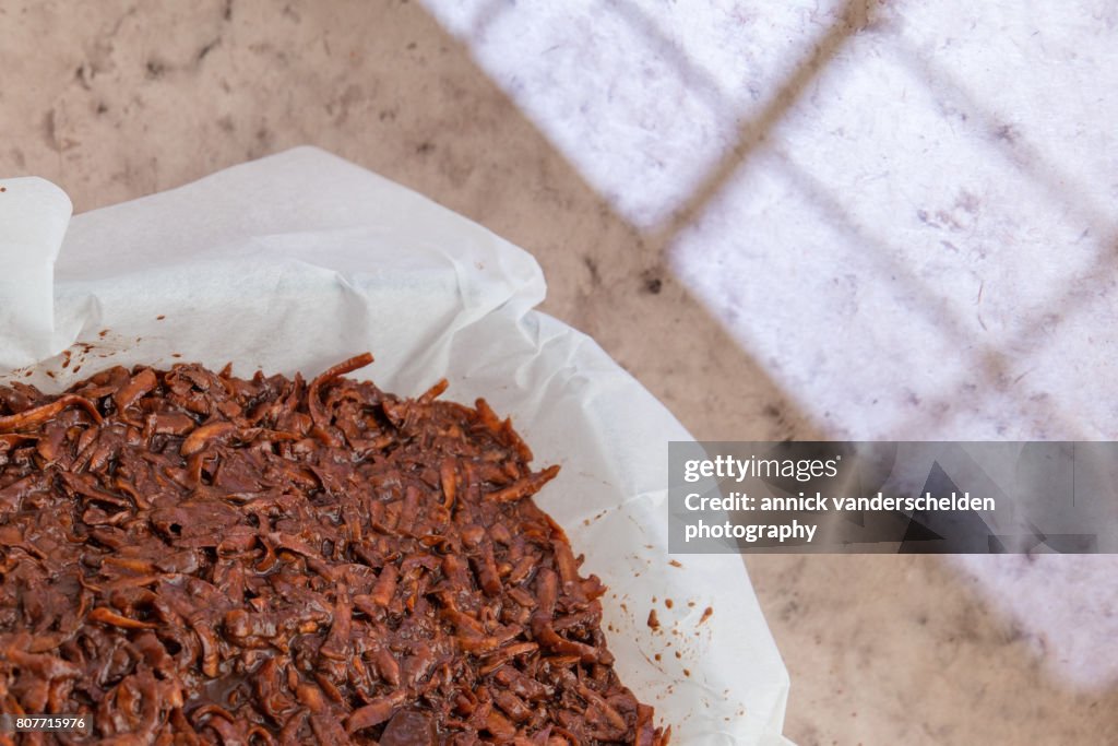 Oven dish with baking paper and brownie of sweet potato batter.