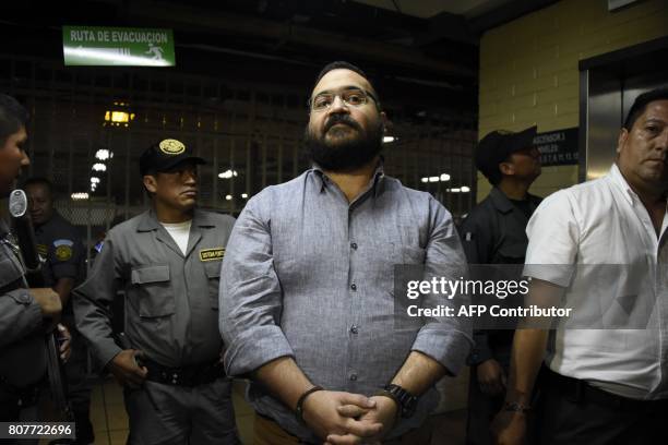 Javier Duarte, former governor of the Mexican state of Veracruz, accused of graft and involvement in organized crime, is escorted by police officers...