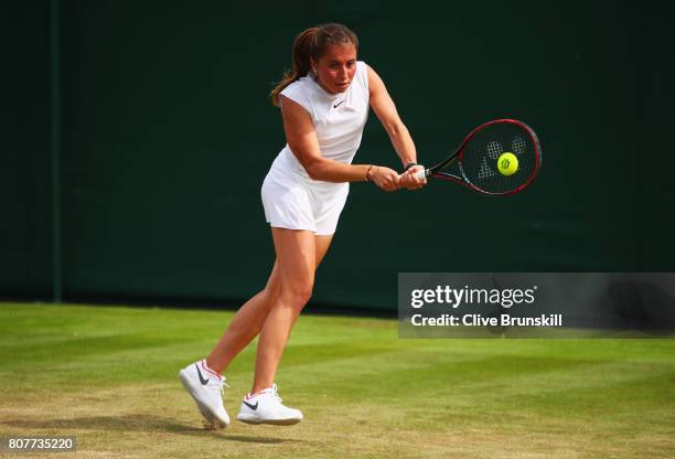 Annika Beck of Germany plays a backhand during the Ladies Singles first round match against Polona Hercog of Slovenia on day two of the Wimbledon...