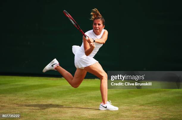 Annika Beck of Germany plays a backhand during the Ladies Singles first round match against Polona Hercog of Slovenia on day two of the Wimbledon...