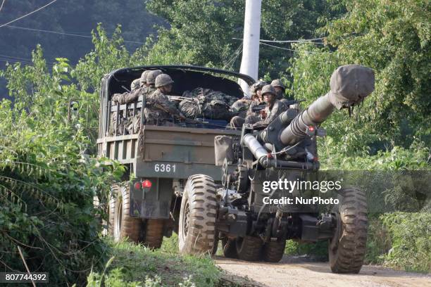 South Korean army soldiers ride on the back of a truck during an annual exercise in Paju, near the border with North Korea, South Korea, Tuesday,...