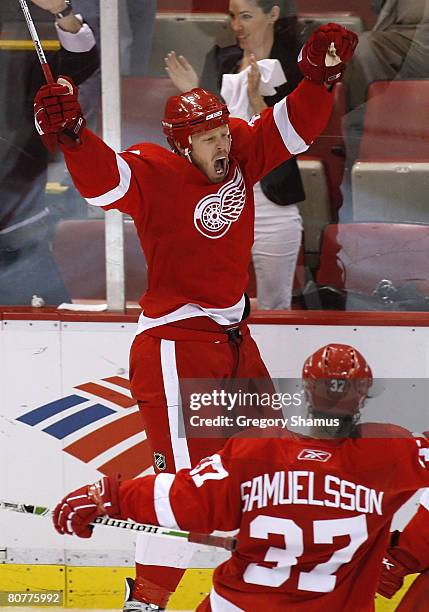 Johan Franzen of the Detroit Red Wings celebrates his overtime game winning goal against the Nashville Predators with Mikael Samuelsson during game...