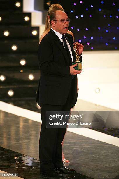 Talian actor Carlo Verdone holds the David di Donatello statuette after being awarded for his carear during the David di Donatello movie award at the...