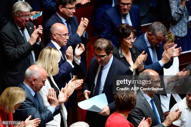 Members of Parliement of Les Republicains party's group applaud their president, Christian Jacob after he delivered a speech following the French...