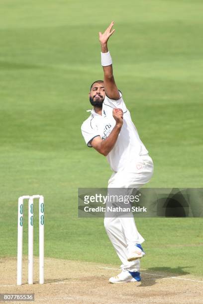 Jeetan Patel of Warwickshire runs in to bowl during the Specsavers County Championship Division One match between Warwickshire and Middlesex at...