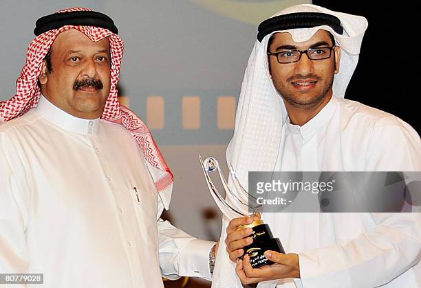 Emirati director Abdullah Hassan Ahmed receives his award for the best short film award, 'Tenbak' or 'Tobacco' at the Gulf Film Festival in Dubai,...