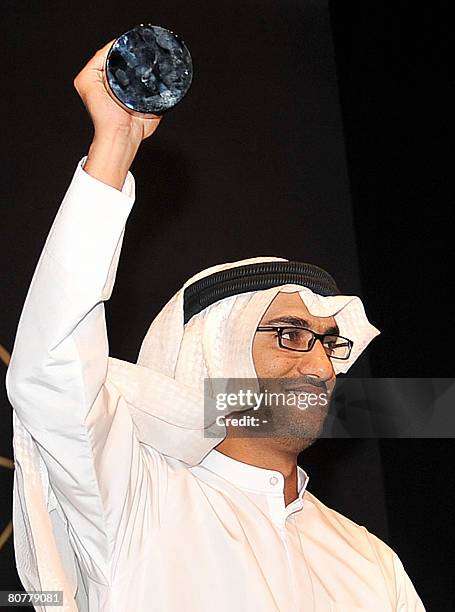 Emirati director Abdullah Hassan Ahmed receives an award for the best short film 'Tenbak' or 'Tobacco' at the Gulf Film Festival in Dubai, late April...