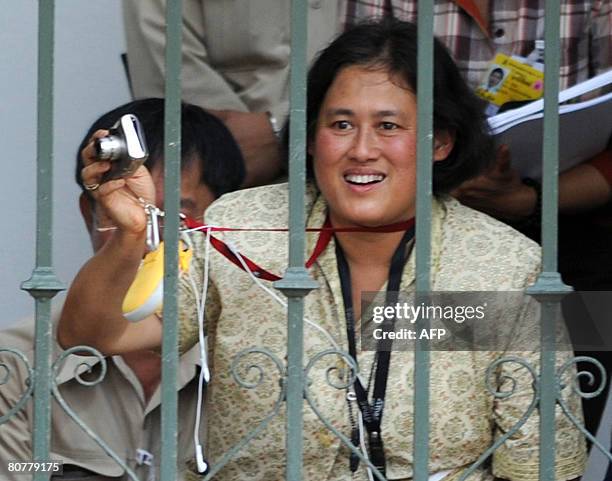 Thai Crown Princess Sirindhorn smiles as she looks at the Beijing Olympic Torch relay as it passes Chitralada palace in Bangkok on April 19, 2008....