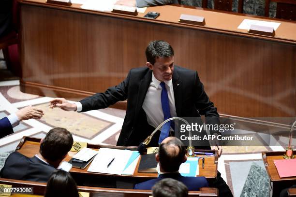 Former French prime minister and Member of Parliament Manuel Valls shakes hand with members of the government within the address of the French Prime...