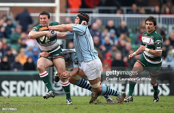 Aaron Mauger of Leicester Tigers is tackled by Dan Ward-Smith of Bristol during the Guinness Premiership match between Leicester Tigers and Bristol...