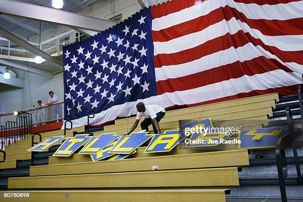 Norman Jacobs removes a sign, reading Hillary, after a rally by Democratic presidential hopeful U.S. Senator Hillary Clinton at Wilson Senior High...