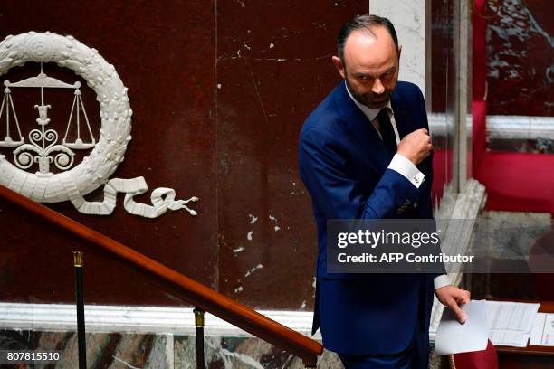 French Prime Minister Edouard Philippe leaves after addressing his general policy speech before the National Assembly on July 4, 2017 in Paris. / AFP...