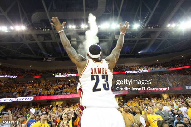 LeBron James of the Cleveland Cavaliers applies chalk to his hands during the game against the Washington Wizards in Game One of the Eastern...