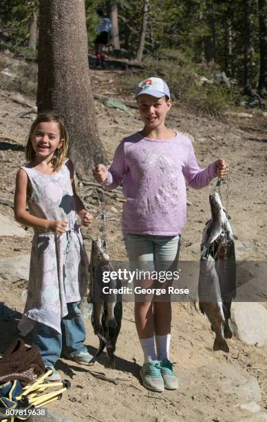 Two kids display their afternoon catch of trout on June 29 in Mammoth Lakes, California. With a record winter and spring snowfall of 616 inches...