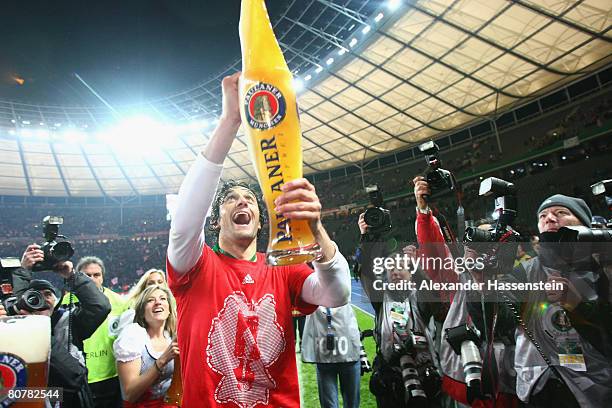 Luca Toni of Bayern Munich enjoys a glas of beer after winning the German Cup Final against Borussia Dortmund at the Olympic stadium on April 19,...