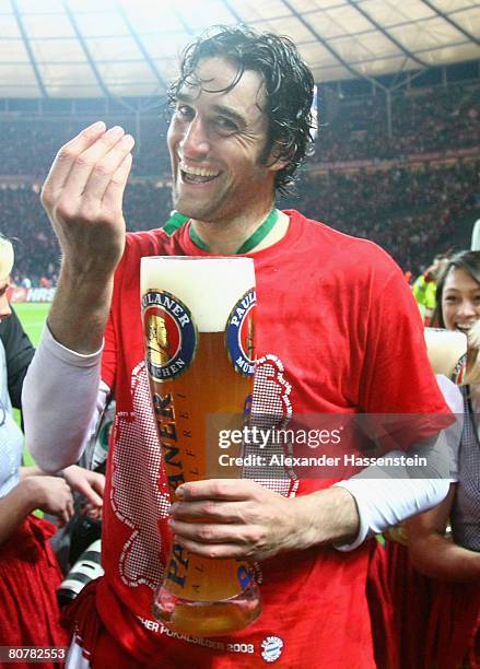 Luca Toni of Bayern Munich enjoys a glas of beer after winning the German Cup Final against Borussia Dortmund at the Olympic stadium on April 19,...