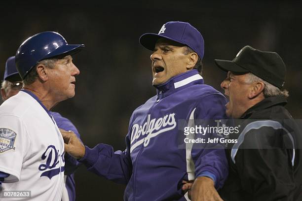 Los Angeles Dodgers manager Joe Torre attempts to break up an arguement between third base umpire Ed Montague and third base coach Larry Bowa in the...