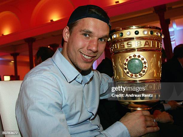 Lukas Podolski holds the trophy during the Bayern Munich champions party after the DFB Cup Final match between Borussia Dortmund and FC Bayern Munich...