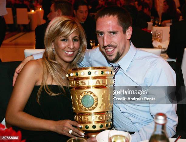 Franck Ribery and his wife Wahiba Ribery hold the trophy during the Bayern Munich champions party after the DFB Cup Final match between Borussia...