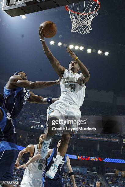 Chris Paul of the New Orleans Hornets shoots over Erick Dampier of the Dallas Mavericks in Game One of the Western Conference Quarterfinals during...