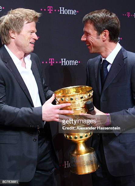 Oliver Kahn of Bayern Munich, holds the DFB-Trophy with Rene Obermann, CEO of Deutsche Telekom during the Bayern Munich champions party after the DFB...