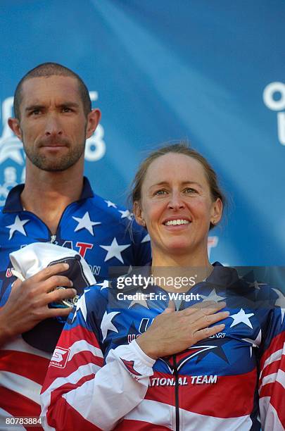 Matthew Reed, left and Julie Swail Ertel, listen to the National Anthem on the podium after winning the U.S. Olympic Team Trials for Triathlon on...