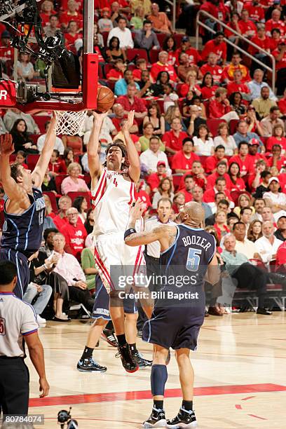 Luis Scola of the Houston Rockets shoots the ball over Mehmet Okur of the Utah Jazz in Game One of the Western Conference Quarterfinals during the...