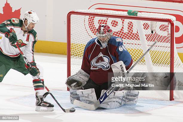 Brian Rolston of the Minnesota Wild shoots against Goaltender Jose Theodore of the Colorado Avalanche during game six of the Western Conference...